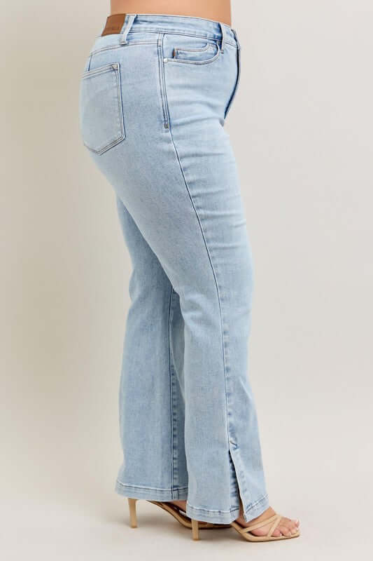 Judy Blue plus size tummy control jeans in vintage wash with side slits and slim boot cut, showcasing a flattering fit.