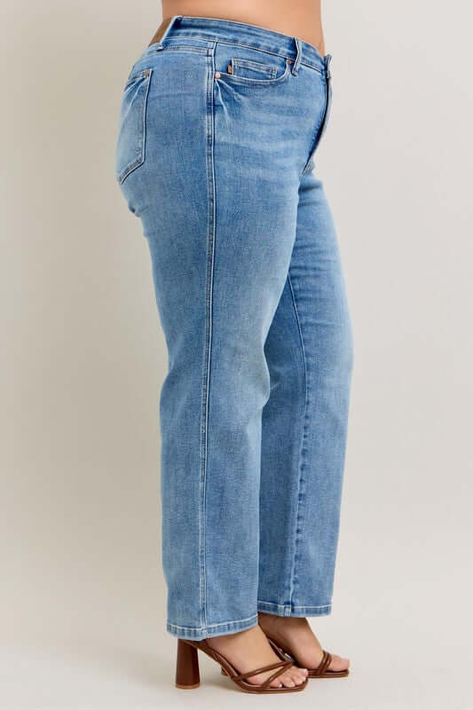 Side view of Judy Blue tummy control vintage wash straight jeans plus size, showcasing their flattering fit and modern style.