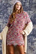 Model wearing a multicolored distressed hem tunic dress with a cozy cardigan and beanie, perfect for trendy casual outfits.