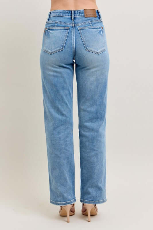 Back view of Judy Blue plus size tummy control vintage wash straight jeans for a flattering fit.