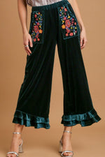 Umgee plus size wide fit ruffle velvet pants with colorful embroidered pockets, perfect for stylish comfort.