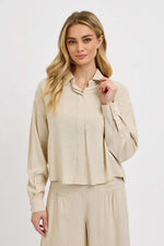 RISEN Button Down Long Sleeve Shirt in beige, featuring a classic design and long sleeves, perfect for versatile styling.