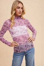 Woman wearing Annie Wear Floral Lettuce Hem Sheer Mesh Top with purple floral pattern, showcasing a stylish and trendy design.