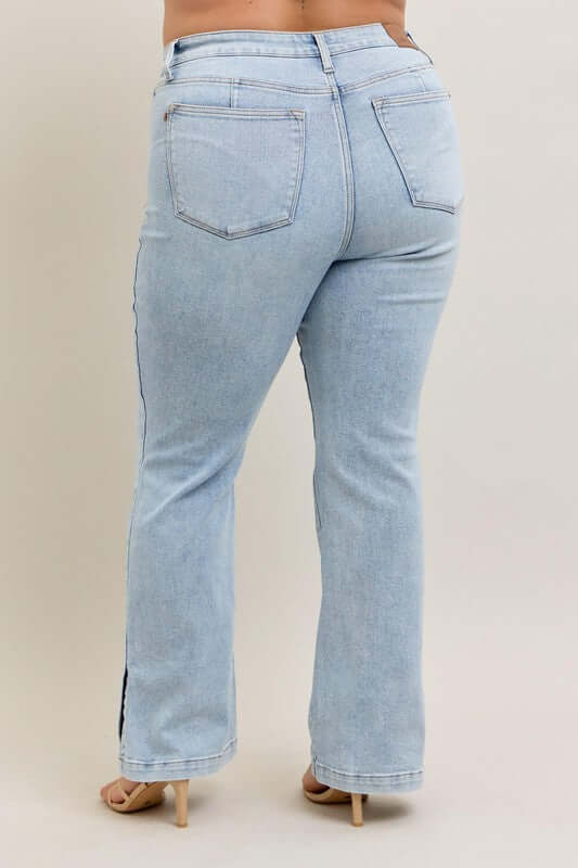 Back view of Judy Blue Plus Size Tummy Control Vintage Wash Side Slit Slim Boot Jeans, showcasing stylish denim fit.