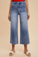 Annie Wear high rise wide leg jeans in light wash, showcasing a flattering silhouette and retro style.