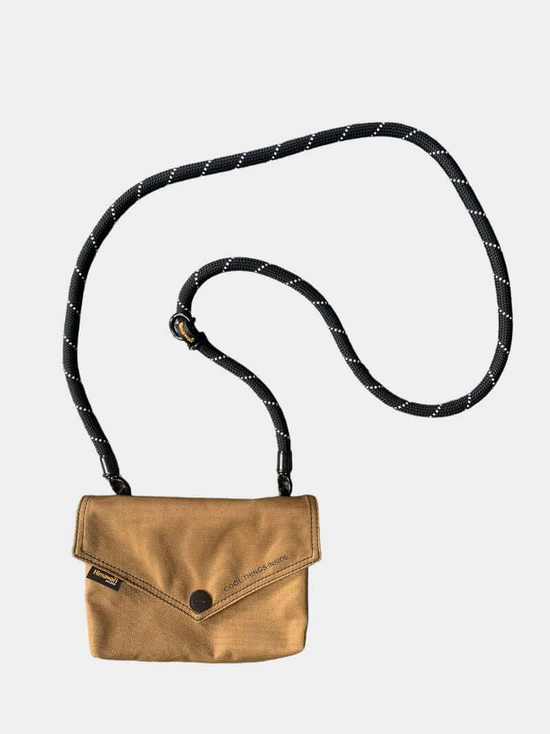 Himawari solid color envelope shape crossbody bag with removable strap in tan, featuring a stylish black and white strap.
