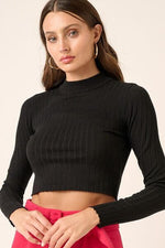 Model showcasing Mittoshop Mock Neck Long Sleeve Crop Knit Top in black, styled for a chic, modern look.
