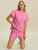 Playful pink textured T-shirt and shorts set for stylish comfort and versatility.
