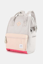 Stylish gray and pink waterproof backpack with USB port, perfect for travel and outdoor adventures.