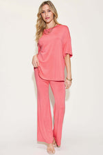 Woman wearing a pink Bamboo Drop Shoulder T-Shirt and Flare Pants Set, featuring a basic style and stretchy bamboo fiber material.