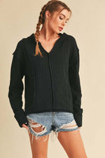 Aemi + Co frayed hem long sleeve hoodie styled with distressed denim shorts on a model.