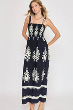 Stylish plus size smocked printed wide leg jumpsuit with navy and white design, perfect for summer outings.