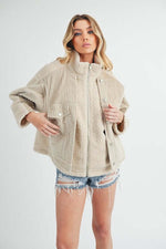 Stylish model wearing Aemi + Co fake two pieces turtleneck Sherpa jacket with pockets, perfect for chilly weather.