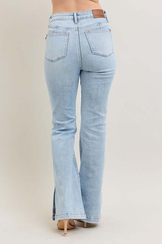 Back view of Judy Blue full size tummy control vintage wash side slit slim boot jeans in light blue.