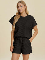 Model showcasing the stylish Double Take black textured T-Shirt and Shorts Set, perfect for a chic, casual look.