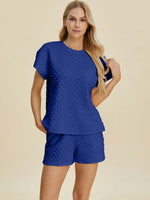 Model showcasing the Double Take Full Size Texture T-Shirt and Shorts Set in royal blue.
