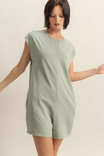 Trendy model wearing a HYFVE Round Neck Cap Sleeve Relaxed Fit Breezy Romper in soft green, perfect for warm summer days.