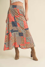 Colorful Aemi + Co printed maxi skirt with floral patterns, perfect for summer style and casual outings.