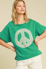 Chic green oversized t-shirt with peace sign graphic, perfect for casual, stylish outfits.