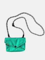 Stylish turquoise envelope shape crossbody bag with removable strap for versatile fashion.