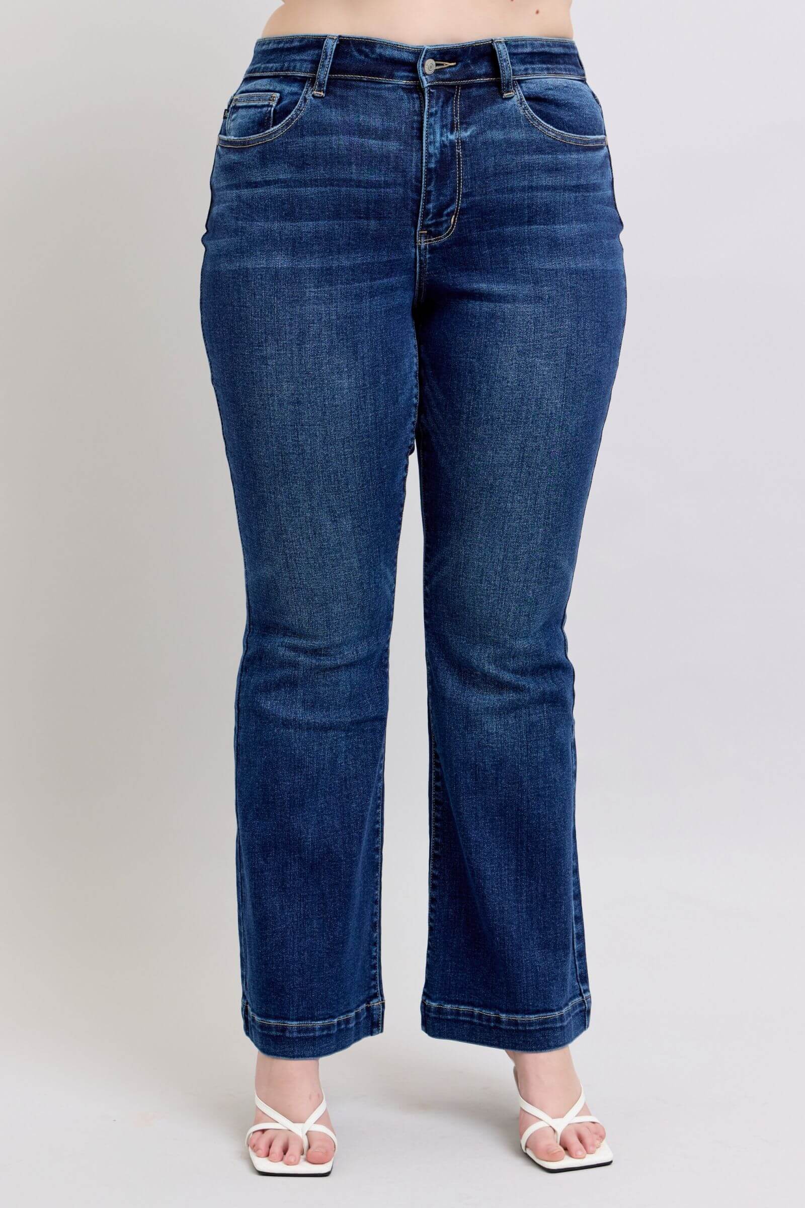 Judy Blue high rise flare jeans in dark wash with pockets, perfect for a trendy casual look in plus sizes.