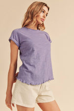 Aemi + Co Lettuce Edge Round Neck Short Sleeve T-Shirt in purple, styled with casual shorts for a trendy look.