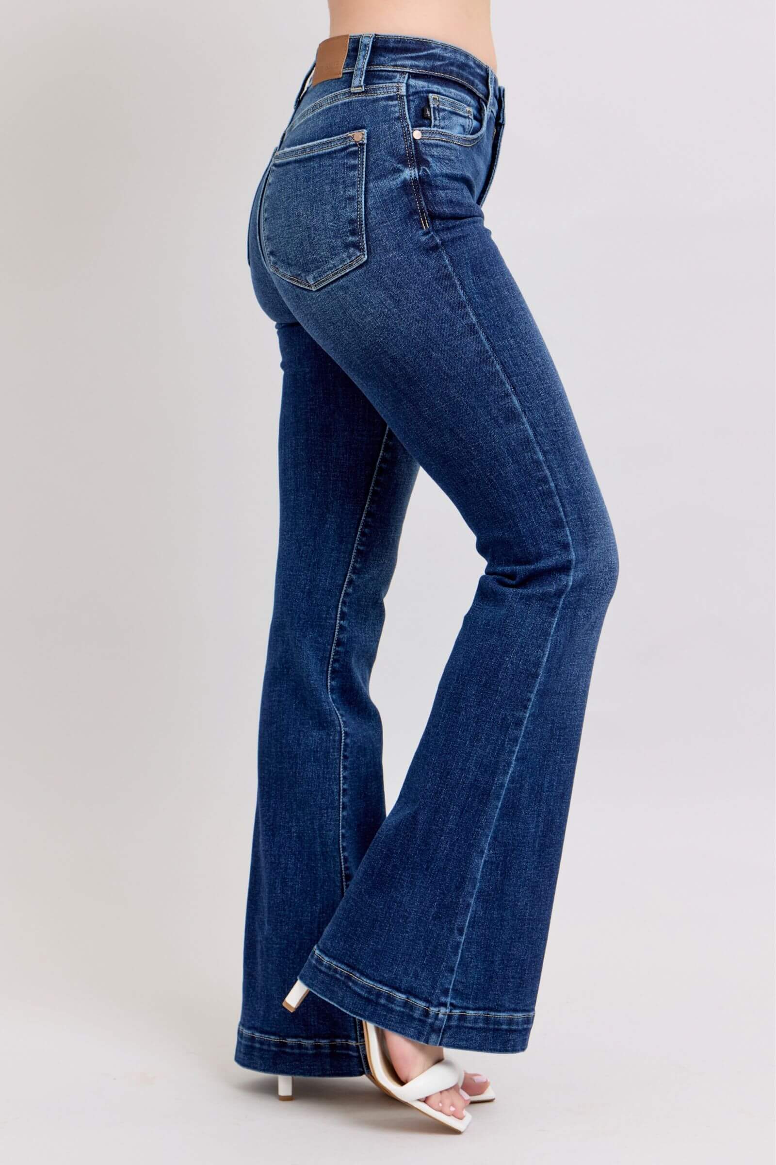Judy Blue high rise flare jeans with pockets in dark wash, showcasing a chic retro style and flattering fit.