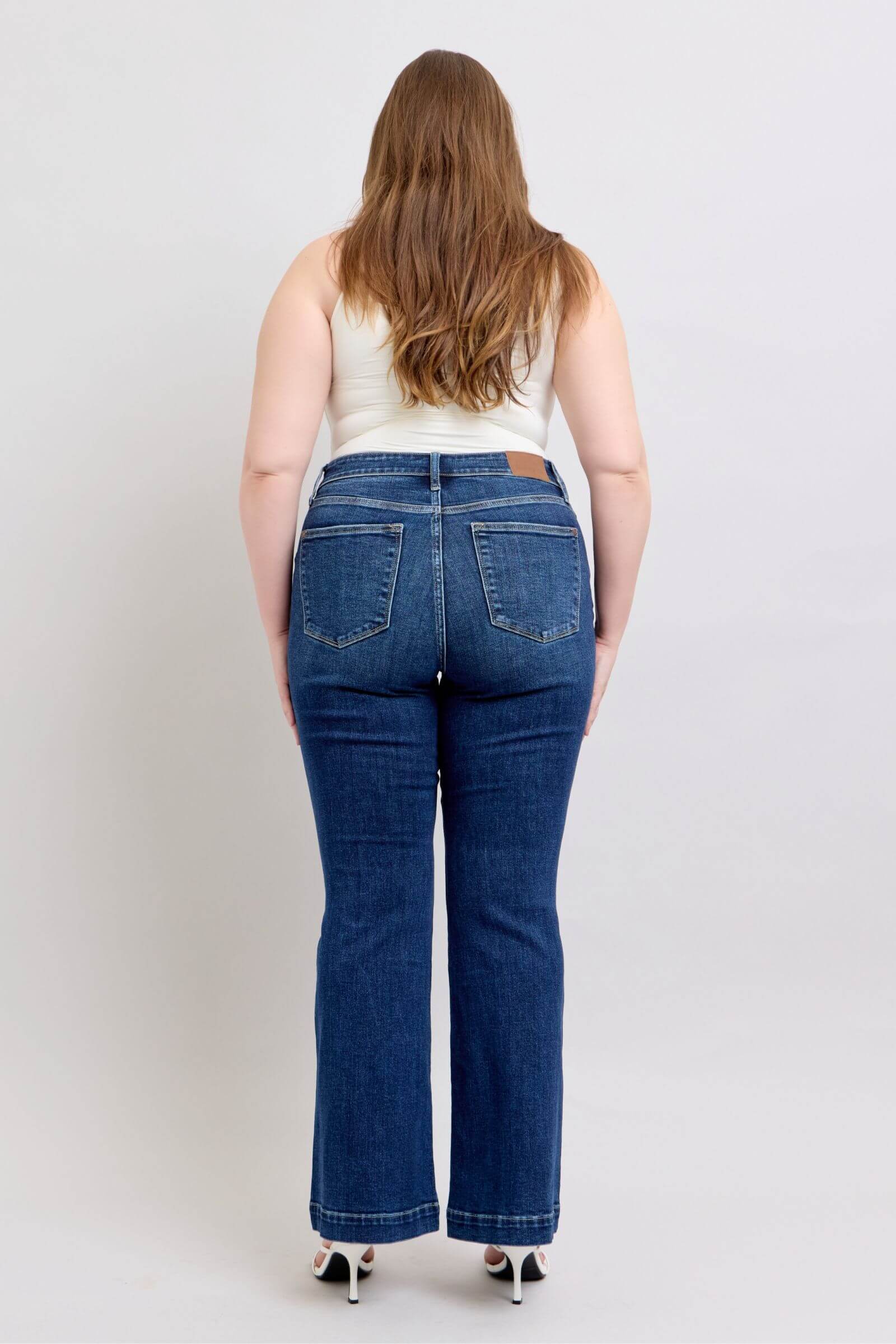 Back view of Judy Blue plus size high rise flare jeans with pockets, stylish and flattering fit.