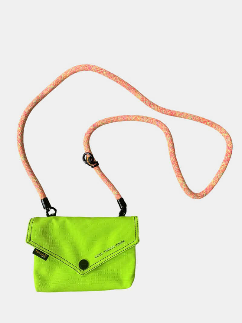 Vibrant green envelope shape crossbody bag with pink removable strap for stylish versatility.