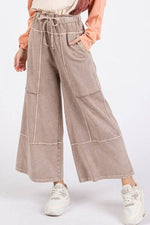 Model wearing Mittoshop Mineral Wash Seam French Terry Wide Leg Pants in vintage hue, showcasing a relaxed style and seamless pockets.