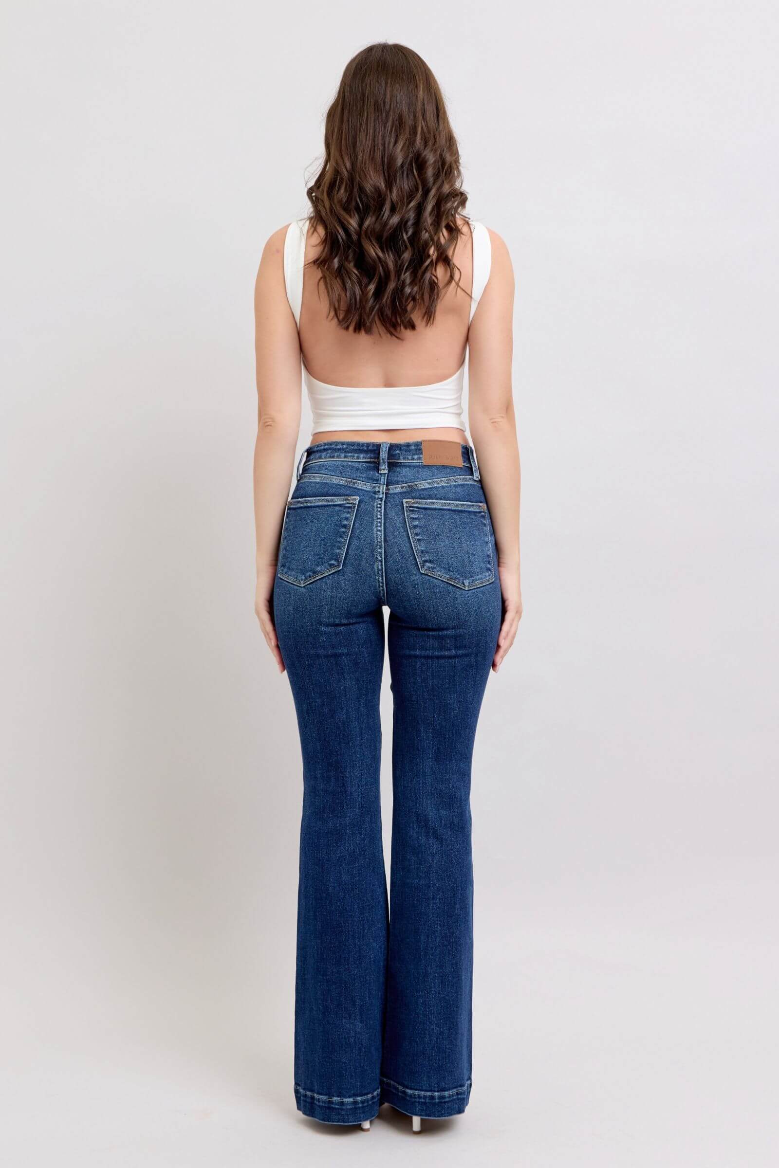 Back view of Judy Blue full-size high rise flare jeans with pockets, showcasing stylish retro flair and flattering fit.