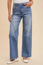 Stylish woman in Annie Wear decorative seams wide leg jeans, showcasing modern design and chic silhouette.