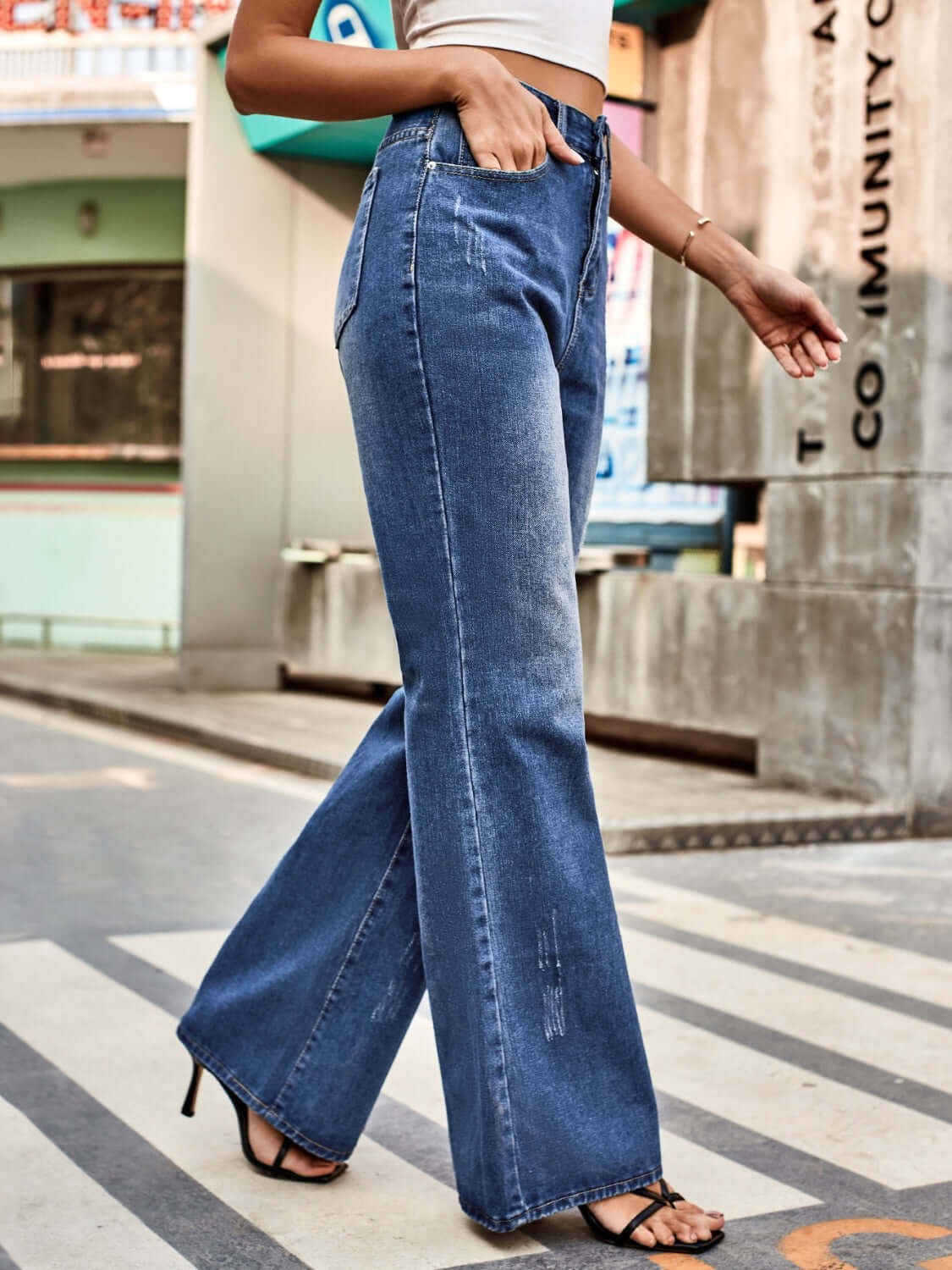 Woman wearing Bella Road High Rise Bootcut Jeans with Pockets, featuring a flattering fit and trendy bootcut style, perfect for any outing.