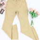 Beige pocketed raw hem flare jeans displayed with a bouquet of pink tulips and a makeup palette on a white background