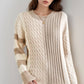 Woman wearing Bella Road cable-knit color block round neck tan sweater, showcasing stylish and cozy fashion.