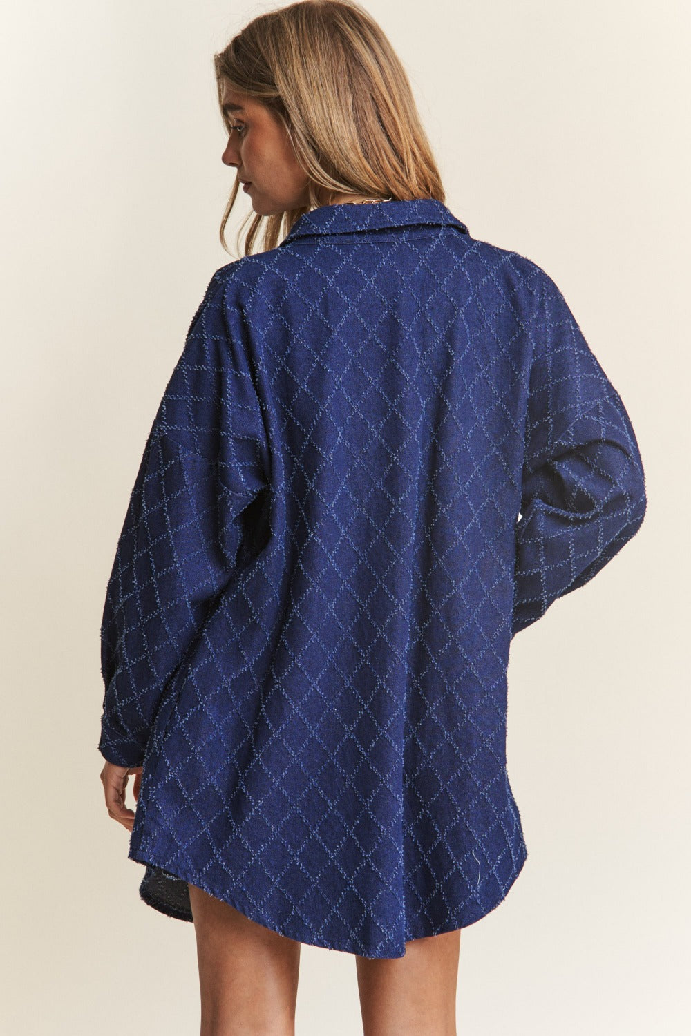 Woman wearing a J.NNA rhombus stitched button-up denim shacket with a stylish oversized fit, showcasing the unique pattern.