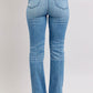 Back view of Judy Blue high waist slim bootcut jeans with vintage wash and side slit details.