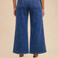 Back view of Annie Wear button fly high waist jeans with wide legs, styled with a striped top and ankle boots.