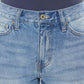 Close-up of high waist chewed up straight mom jeans with distressed detailing and frayed edges.