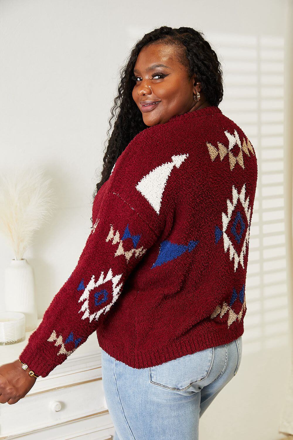 Woman wearing HEYSON full size Aztec soft fuzzy sweater in red with intricate pattern, showcasing cozy and stylish design.