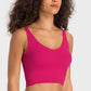 Model wearing Millennia Deep V-Neck Crop Sports Bra in vibrant pink, showcasing a stylish and comfortable athletic look.