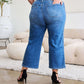 Woman modeling Judy Blue Jeans with braid side detail and wide leg silhouette, back view.