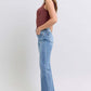 Stylish model showcasing Judy Blue high rise bootcut jeans with raw hem, perfect for a trendy and flattering look.