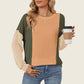 Stylish woman wearing Double Take Texture Contrast Round Neck Long Sleeve T-Shirt in trendy colors holding coffee cup.