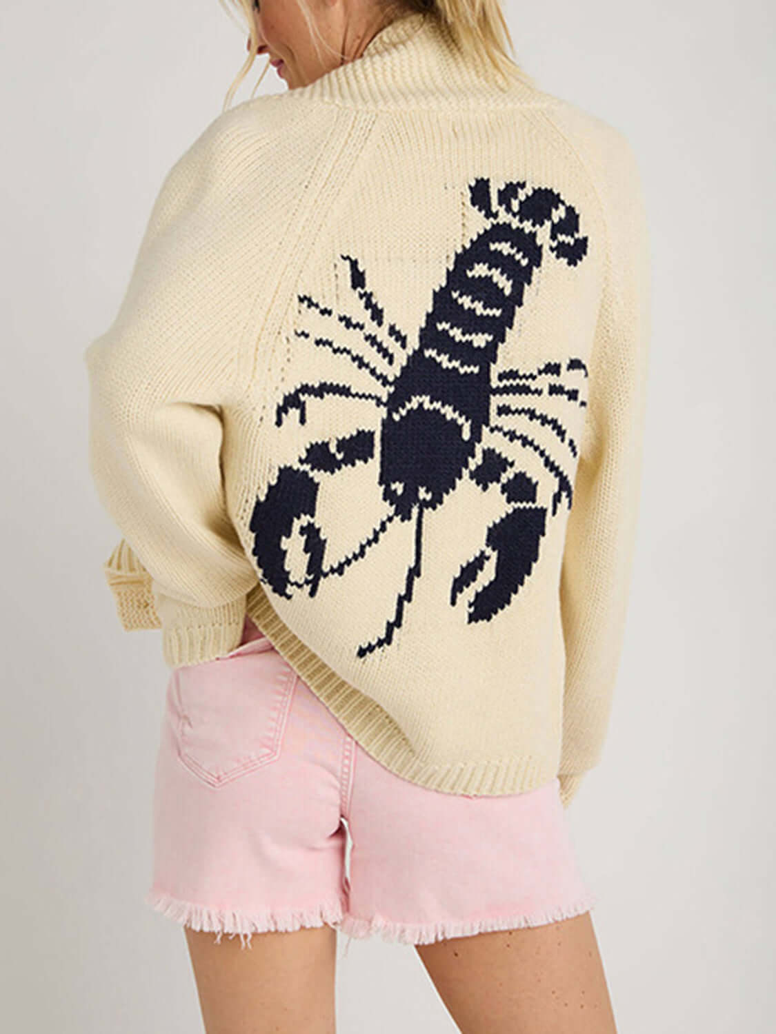 Woman wearing Bella Road Lobster Button Up Long Sleeve Cardigan with playful lobster design on back. Perfect for a touch of fun.