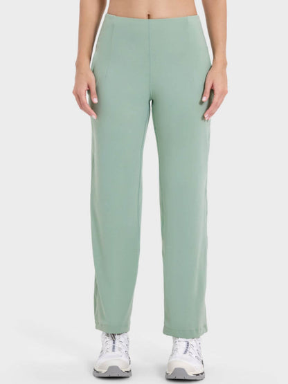 Millennia Pocketed High Waist Active Pants in soft green, perfect for workouts with pockets for essentials.