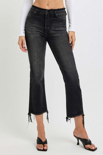 Plus size raw hem cropped flare jeans in black, featuring a trendy retro silhouette and frayed edges for a stylish look.