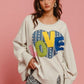 Cozy Love Heart Patch Slit French Terry Sweatshirt on model, featuring playful heart design and trendy slit details.