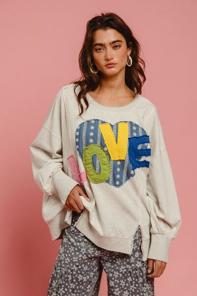 Cozy Love Heart Patch Slit French Terry Sweatshirt on model, featuring playful heart design and trendy slit details.