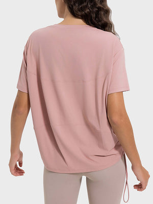 Back view of Millennia Drawstring Round Neck Short Sleeve Active T-Shirt in soft pink, showcasing breathable fabric and relaxed fit.